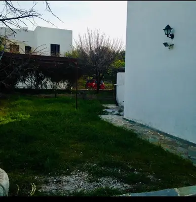 a wall with a light on the side of a building at Lagonisi2025 in Kalívia Thorikoú