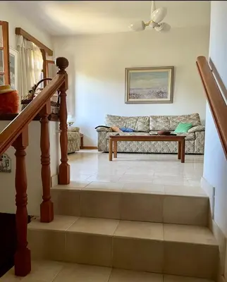 a living room with a couch and stairs at Lagonisi2025 in Kalívia Thorikoú