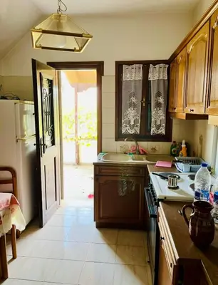 a kitchen with a sink and a refrigerator at Lagonisi2025 in Kalívia Thorikoú