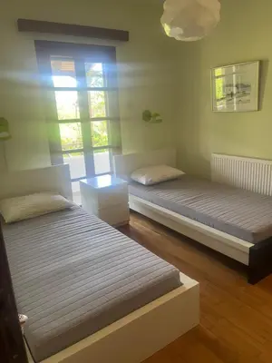 a bedroom with two beds and a window at Lagonisi2025 in Kalívia Thorikoú