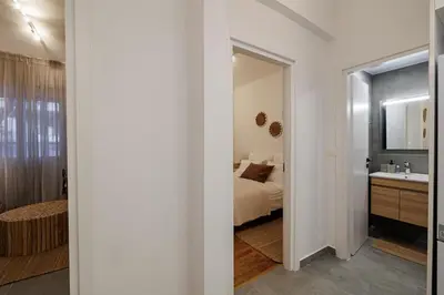 a bedroom with a bed and a sink and a mirror at Sunlit homie flat at Arrianou! in Athens