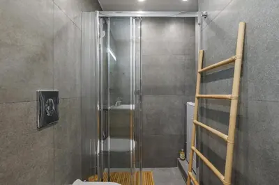 a shower with a glass door in a bathroom at Sunlit homie flat at Arrianou! in Athens