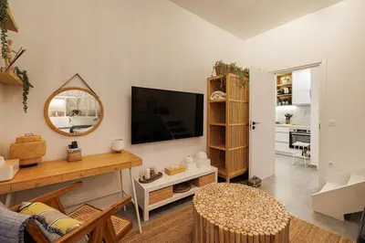 a living room with a flat screen tv on a wall at Sunlit homie flat at Arrianou! in Athens