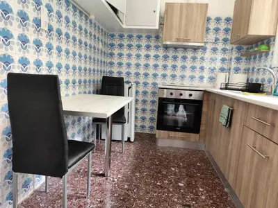 a kitchen with a table and chairs and a stove at Cozy and totally sunny apartment in Athens