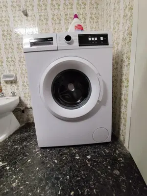 a washing machine in a bathroom next to a toilet at Cozy and totally sunny apartment in Athens