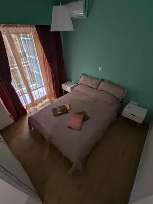 a bedroom with a large bed with two boxes on it at Cozy and totally sunny apartment in Athens