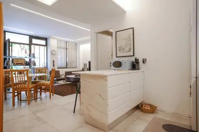 a kitchen and living room with a table and chairs at Lime house in Athens
