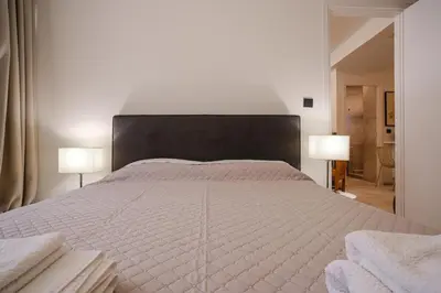 a bedroom with a large bed with two lamps at Lime house in Athens