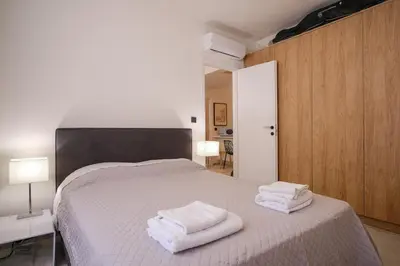 a bedroom with a bed with towels on it at Lime house in Athens
