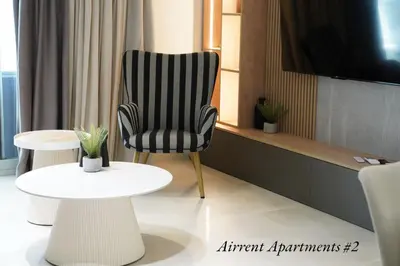 a black and white chair sitting next to a table at Airrent Apartments 2 Designer Stay Free Parking Quiet Central in Athens