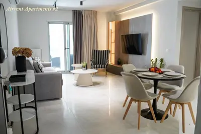 a living room with a couch and a table and chairs at Airrent Apartments 2 Designer Stay Free Parking Quiet Central in Athens