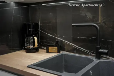 a kitchen counter with a sink and a coffee maker at Airrent Apartments 2 Designer Stay Free Parking Quiet Central in Athens