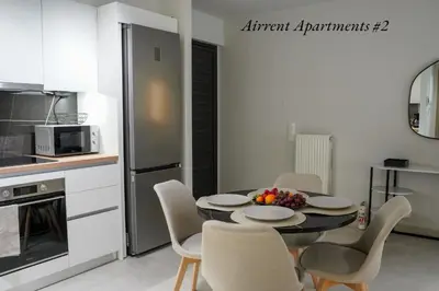 a kitchen with a table and chairs in a room at Airrent Apartments 2 Designer Stay Free Parking Quiet Central in Athens