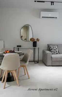 a living room with a couch and a table and chairs at Airrent Apartments 2 Designer Stay Free Parking Quiet Central in Athens