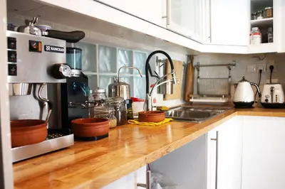 a kitchen with a wooden counter top with a sink at Quiet, central, on airport metro and bus line in Athens