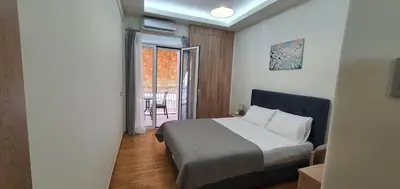 a hotel room with a bed and a balcony at Near the Pasha Limani in Piraeus