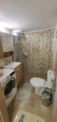 a bathroom with a washing machine and a toilet at Near the Pasha Limani in Piraeus