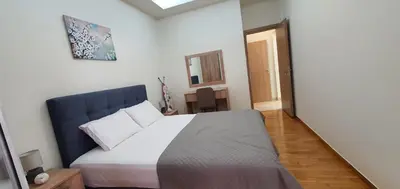 a bedroom with a large bed with a blue headboard at Near the Pasha Limani in Piraeus