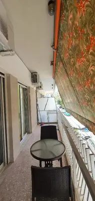 a balcony with a table and chairs in a room at Near the Pasha Limani in Piraeus