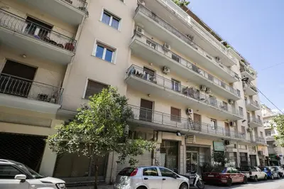 a large apartment building with cars parked on the balconies at Attica - Captivating 2-Bedroom Apt & Balcony in Athens in Athens