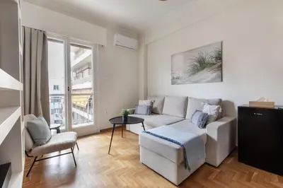 a living room with a couch and a chair at Attica - Captivating 2-Bedroom Apt & Balcony in Athens in Athens