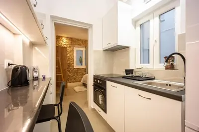 a small kitchen with a sink and a stove at Kastella Luxe Stone in Piraeus