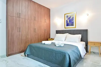 a bedroom with a large bed with towels on it at Acropolis Luxurious Apartment 100 Mbps Metro Garden in Athens