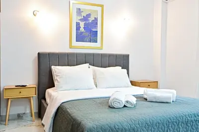 a bedroom with a bed with towels on it at Acropolis Luxurious Apartment 100 Mbps Metro Garden in Athens