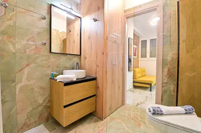 a bathroom with a sink and a shower at Acropolis Luxurious Apartment 100 Mbps Metro Garden in Athens