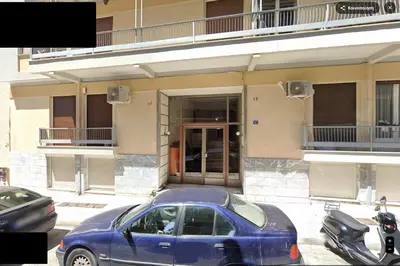 a blue car parked in front of a building at Acropolis Luxurious Apartment 100 Mbps Metro Garden in Athens