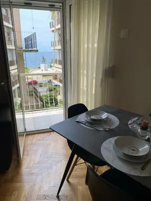 a dining room table with a view of the ocean at Athens Riviera Seaview in Athens