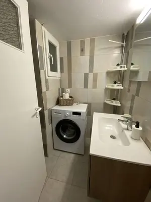 a bathroom with a washing machine and a sink at Athens Riviera Seaview in Athens