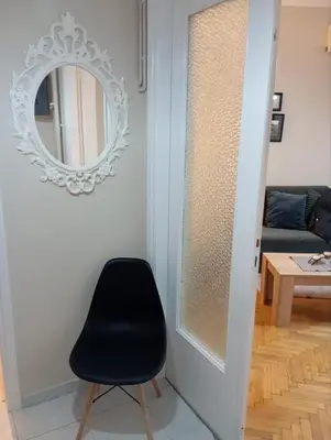 a black chair in a room with a mirror at Athens Riviera Seaview in Athens