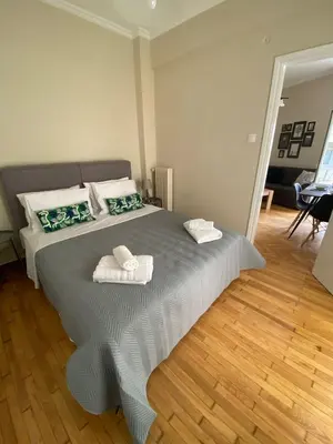 a bedroom with a bed with two towels on it at Athens Riviera Seaview in Athens