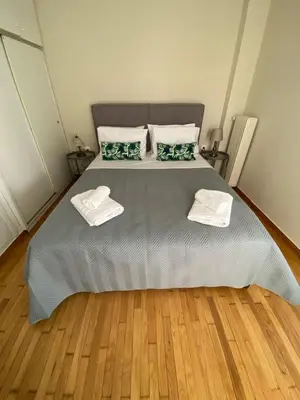 a bedroom with a large bed with two towels on it at Athens Riviera Seaview in Athens