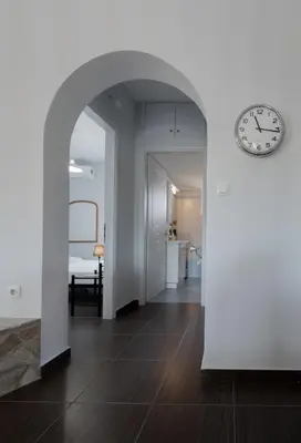 an open hallway with a clock on the wall at Villa PAPADATES NEFELI in Barbaliáki