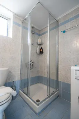 a shower with a glass door in a bathroom at Villa PAPADATES NEFELI in Barbaliáki