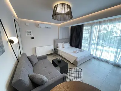 a living room with a couch and a bed at Athenean Cozy Nest in Athens