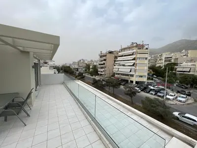 a balcony of a building with a view of a city at Athenean Cozy Nest in Athens