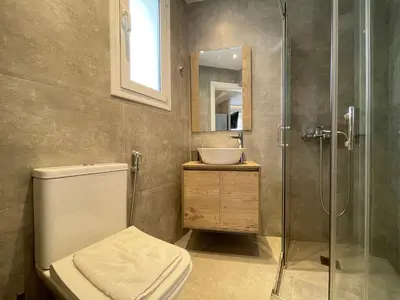 a bathroom with a toilet and a sink and a shower at Athenean Cozy Nest in Athens