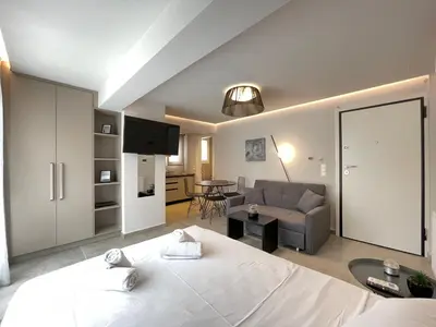 a bedroom with a bed and a living room at Athenean Cozy Nest in Athens