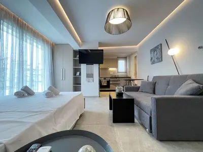 a living room with a bed and a couch at Athenean Cozy Nest in Athens