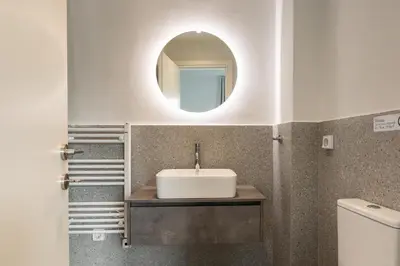 a bathroom with a sink and a mirror at Sol by Zoia Living in Athens