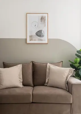 a brown couch in a living room with a picture on the wall at Sol by Zoia Living in Athens