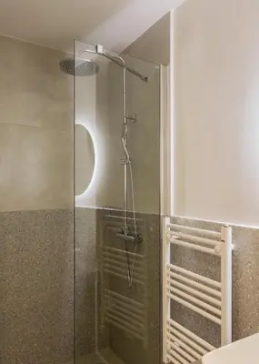 a shower with a glass door in a bathroom at Sol by Zoia Living in Athens