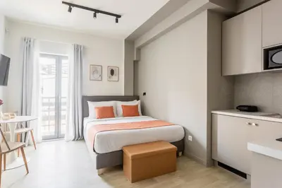 a small bedroom with a bed and a kitchen at Sol by Zoia Living in Athens