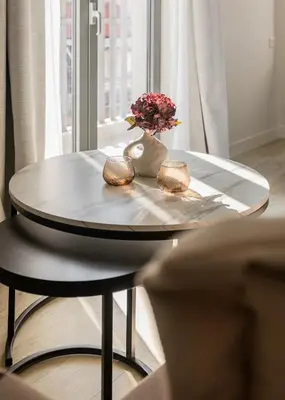 a table with a vase of flowers on top of it at Sol by Zoia Living in Athens