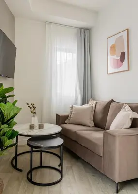 a living room with a couch and a table at Sol by Zoia Living in Athens