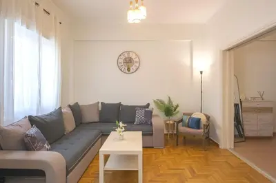 a living room with a couch and a table at Spacious Sunny Apartment in Athens