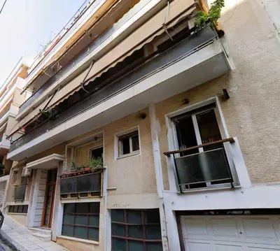 a building with windows and plants on the side of it at Spacious Sunny Apartment in Athens